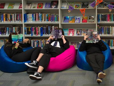 Children in school library reading on bean bags